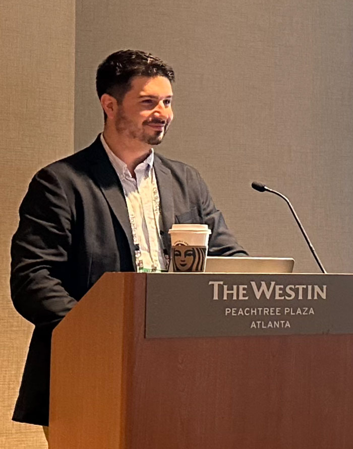 Sean O'Brien speaking behind a podium at The Westin Peachtree plaza Atlanta.