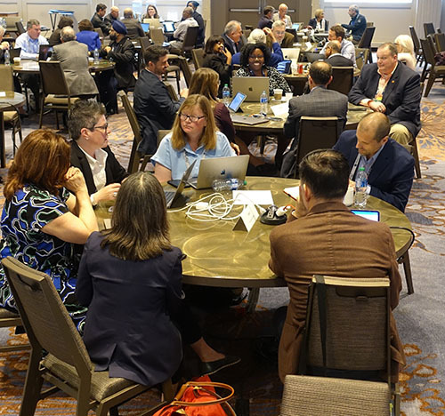 Professionals meeting at a round table during an event.