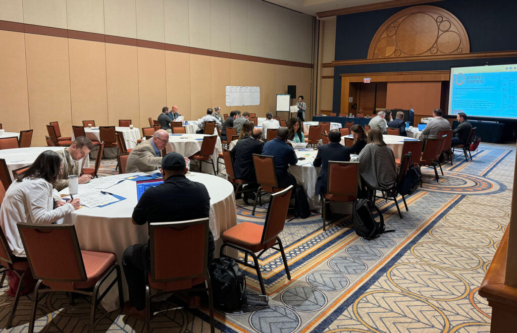 Netta Caligari holding a workshop in a hotel ballroom.