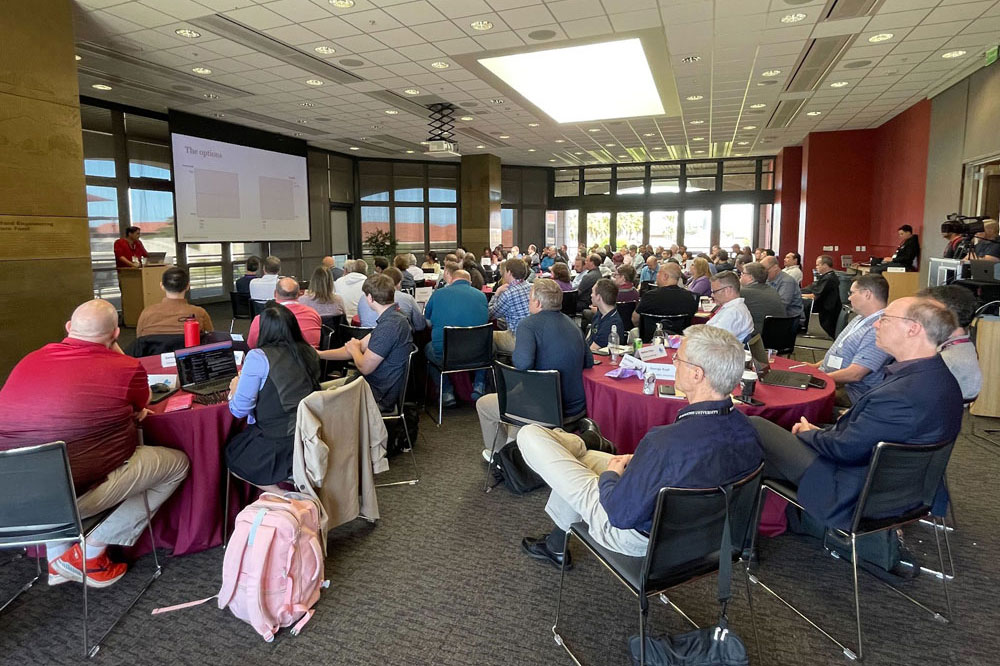 Group of professionals listening to a presenter at cloud forum 2024.