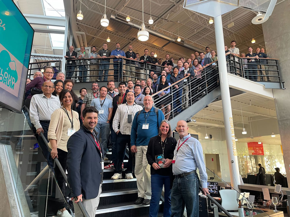 Large group of professionals taking a group photo on a building staircase.