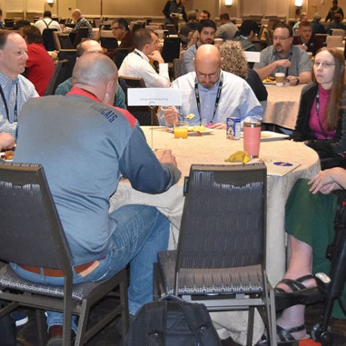 Internet2 event participants sitting at a table