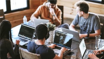 Networking for Cloud image of students working on laptops