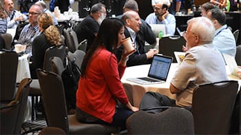 TechEx participants gathering at a table.