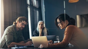 Image of people working together with a laptop