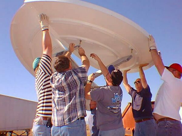 A team constructs a test VSAT dish at the USGS Albuquerque Seismological Laboratory.